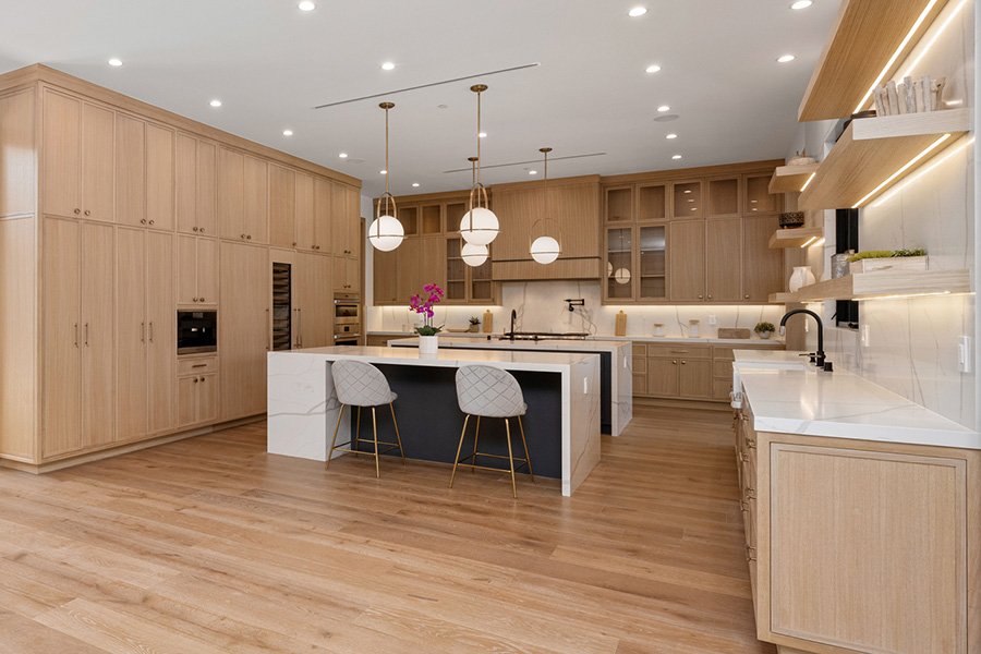 Spacious kitchen with hardwood flooring and wood cabinets