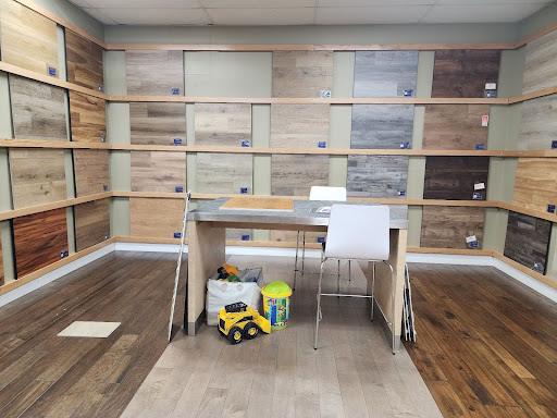 LVP flooring sample area with work table and kids toys, Hanford, CA